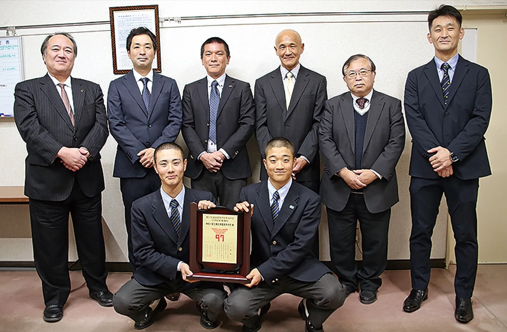 表彰盾を掲げる主将の山本さん（前列右）と内藤さん（同左）。後列左から２人目が野原監督