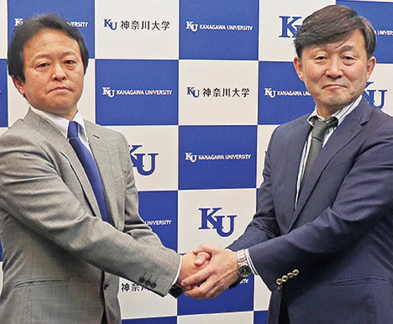 力強い握手を交わす中野さん（左）と大後さん